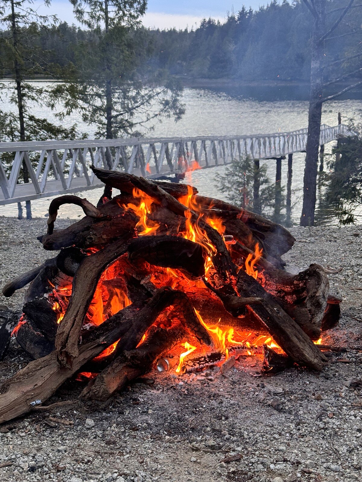 Campfire beside the water at Broken Island Group Properties